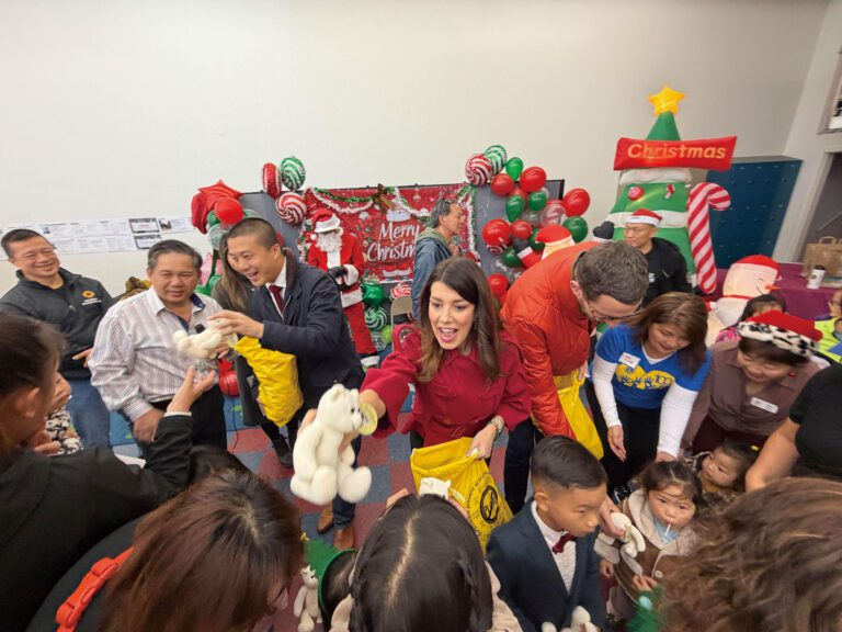 （左三起）王兆倫、司嘉怡和威善高等向兒童派發聖誕玩具，現場洋溢節日氣氛。記者蘇婕雅攝