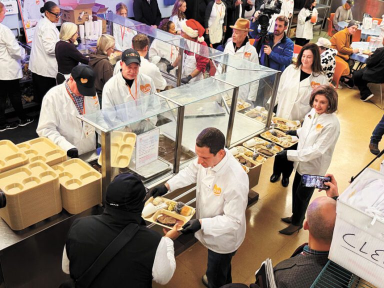 市長羅偉與眾議院榮譽議長普洛西，和義工們一起向民眾派餐。記者蘇婕雅攝