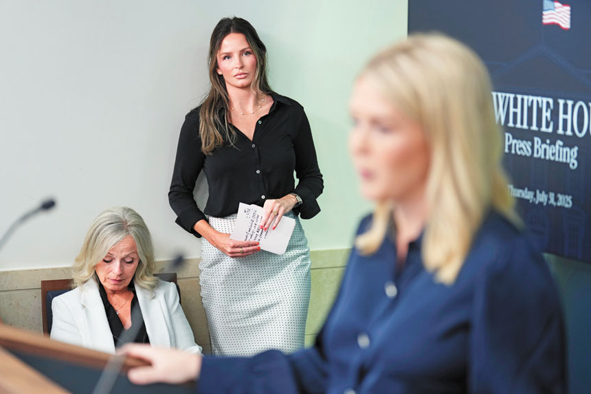 白宮新聞秘書萊維特在白宮記者會上發言,總統特別助理兼傳訊顧問瑪汀(中)在旁聆聽。美聯社資料圖片