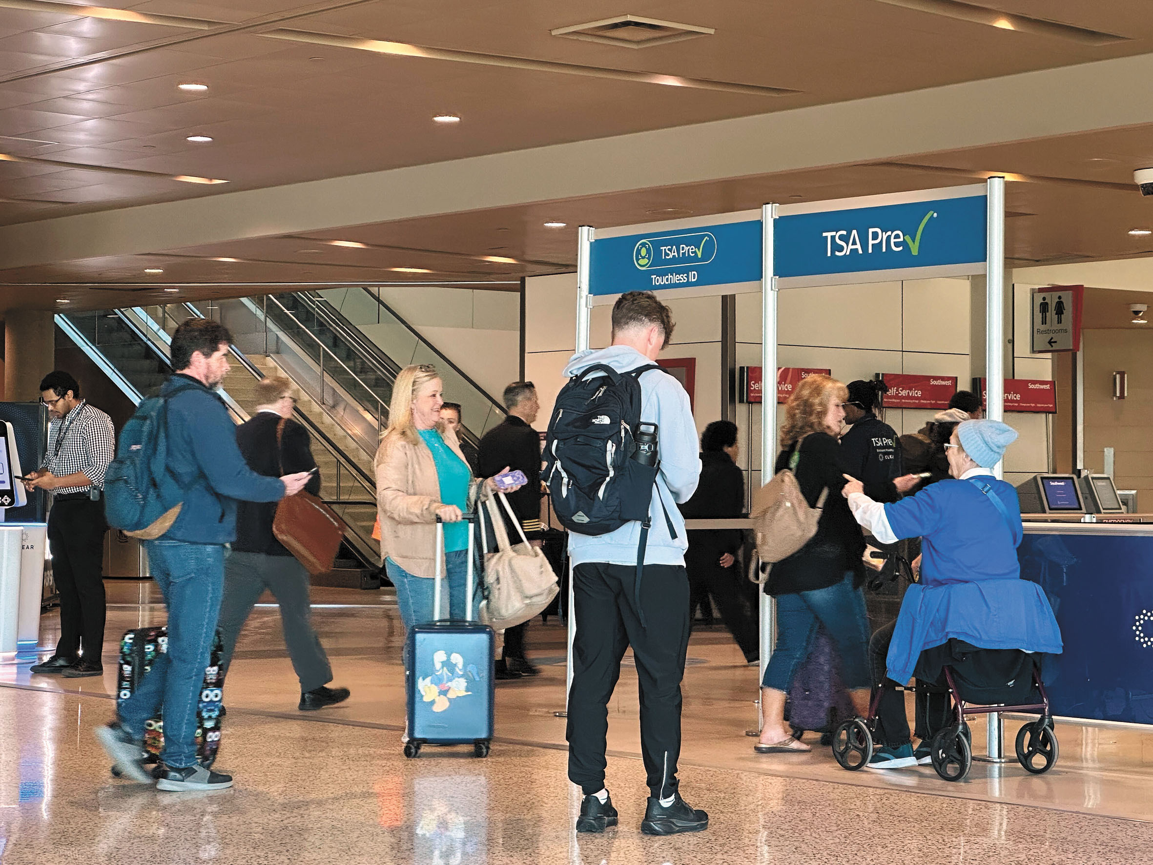 旅客22日走過達拉斯機場的TSA「預檢計劃」通道。 美聯社