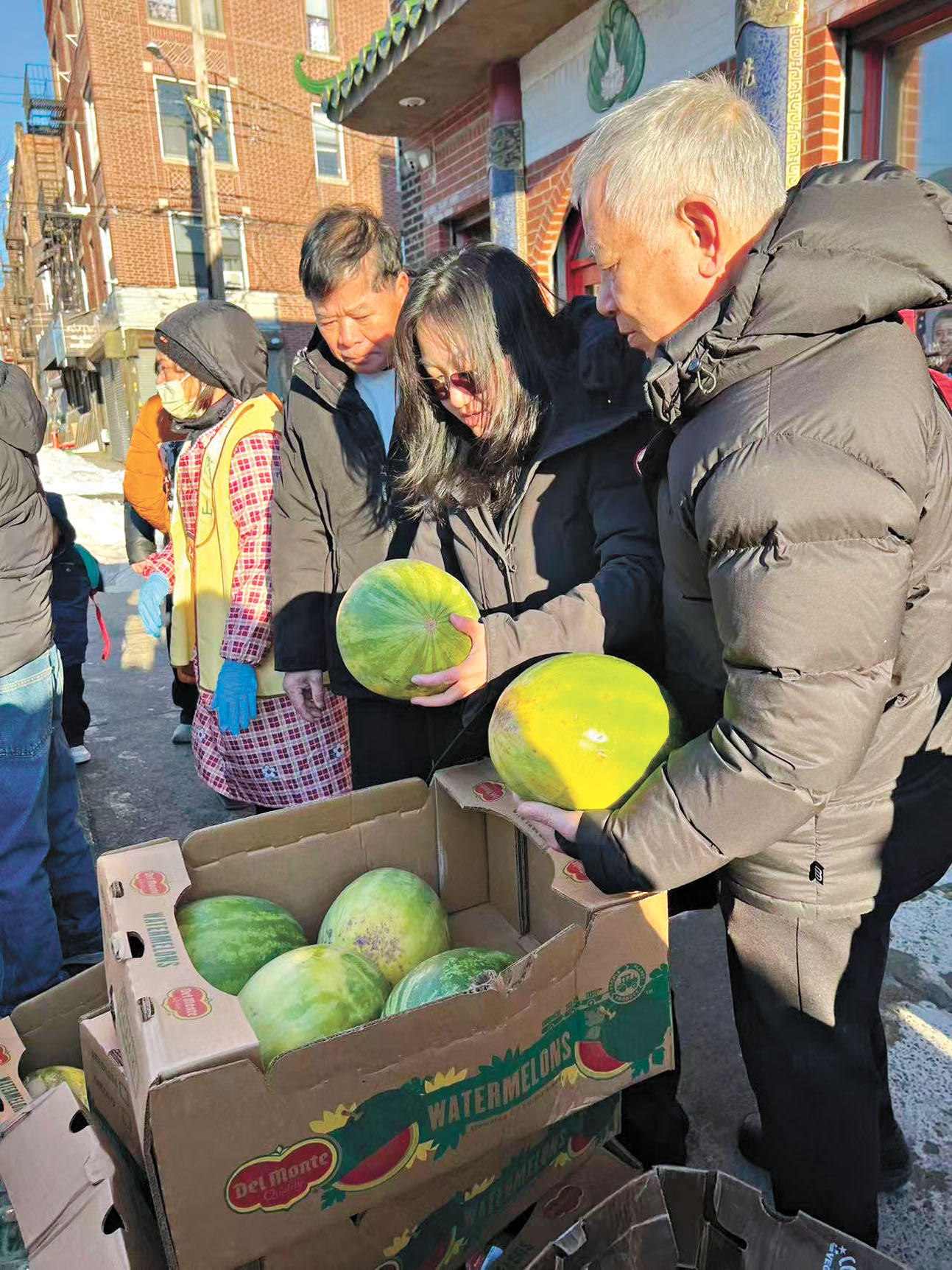 謝曉瓊(右二)2日為民眾派發食物。普陀山紐約梵音寺提供