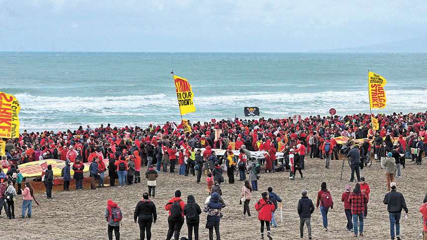 教師罷工第三天，數千名教師與家長冒雨在Ocean Beach排出「FOR OUR STUDENTS STRIKE」標語。記者蘇婕雅攝