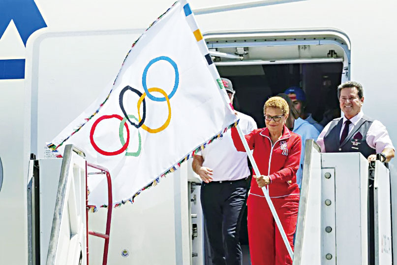 2024年8月，洛杉磯市長巴斯在洛杉磯國際機場手持奧運官方旗幟。美聯社