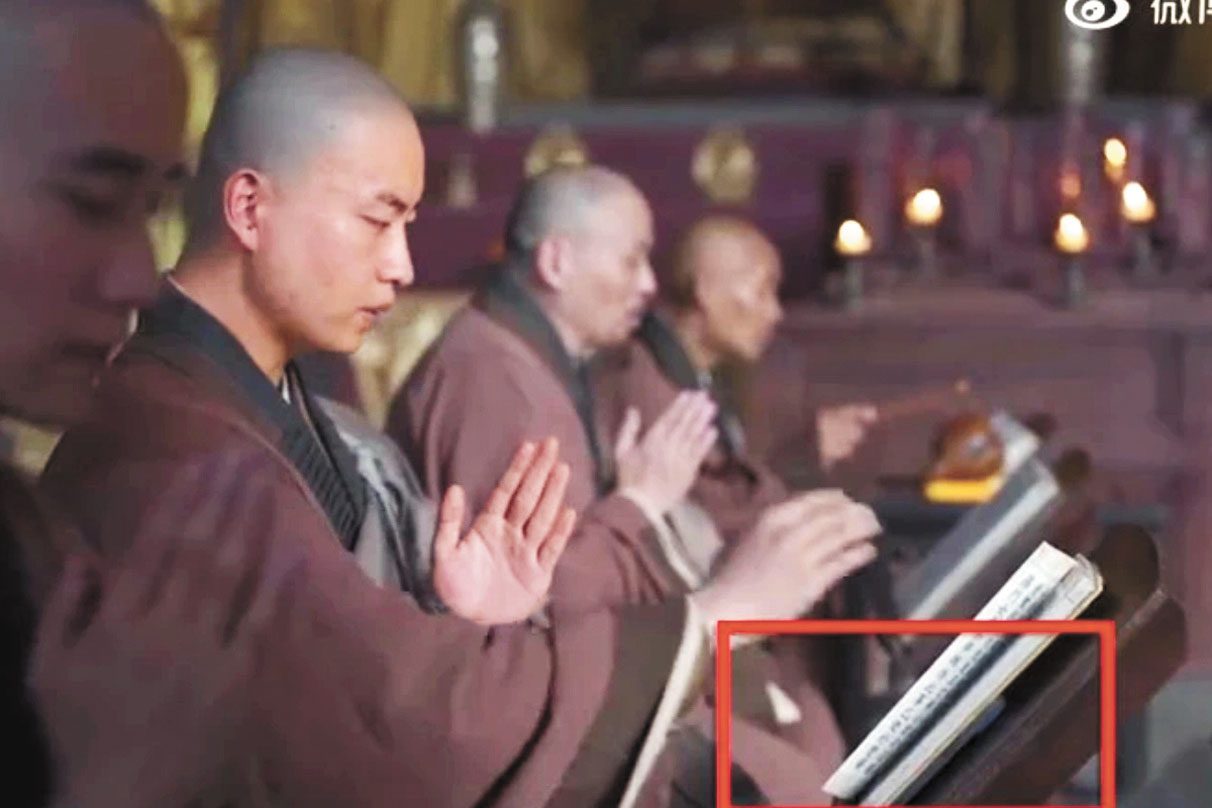 穿幫鏡頭可見，佛經下藏著一部手機。網上圖片