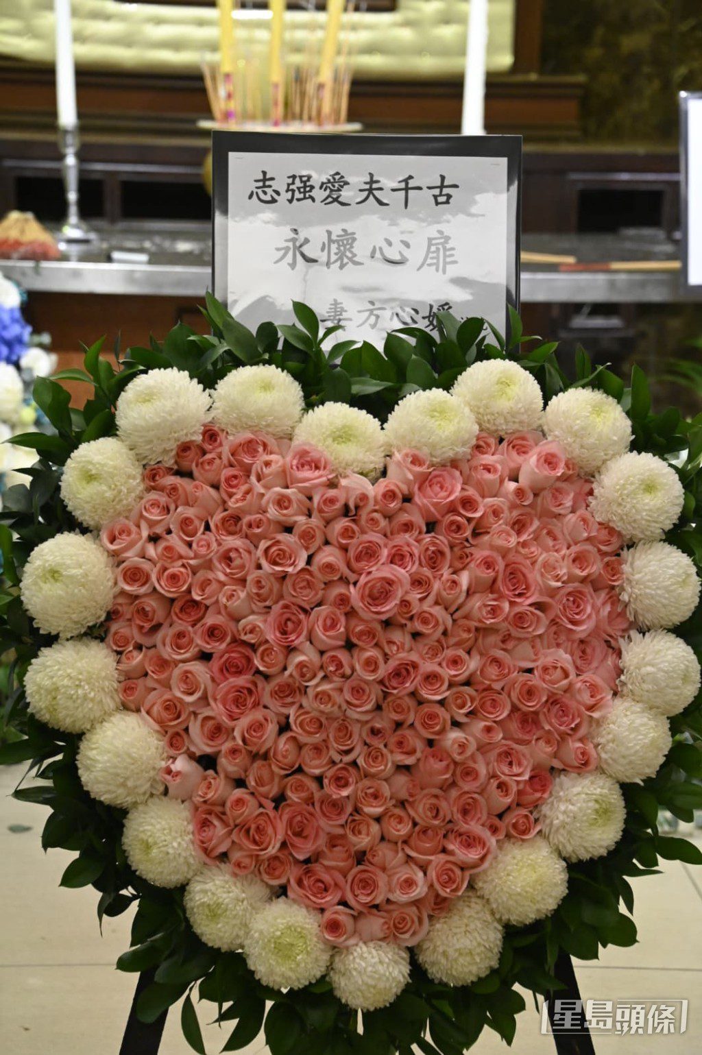 遺孀方心媛致送的心形花牌上寫著「永懷心扉」，寄託對亡夫的無盡思念。